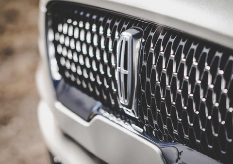 The grille of the 2024 Lincoln Aviator® Reserve model with an eye-catching repeated field of Lincoln Star logo shapes | Ed Morse Lincoln in Muscatine IA