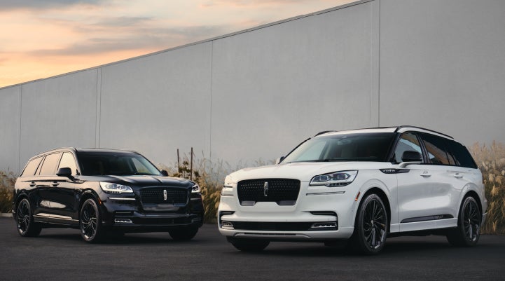 Two Lincoln Aviator® SUVs are shown with the available Jet Appearance Package | Ed Morse Lincoln in Muscatine IA