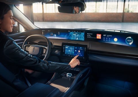 The driver of a 2024 Lincoln Nautilus® SUV interacts with the center touchscreen. | Ed Morse Lincoln in Muscatine IA